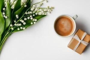 Morning Coffee With Lilies and a Beautifully Wrapped Gift on a White Surface photo