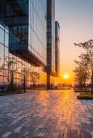 Modern Glass Building Illuminated by Sunset in an Urban Environment. photo