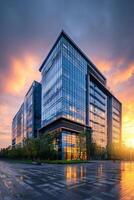 Modern Glass Building Illuminated by Sunset in an Urban Environment photo