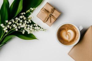 Coffee Cup and Wrapped Gifts Surrounded by Lily of the Valley on White Surface in Morning Light. photo