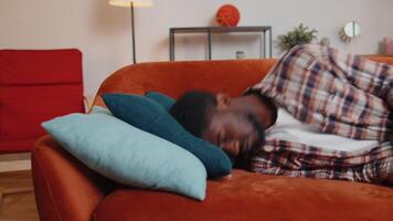 Exhausted overworked african american young man came home after work falling asleep on sofa feels like squeezed lemon. Concept after party, tired overworked person hard day, lack of energy, breakdown video