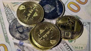 Bitcoin BTC coin and Ethereum ETH coins are rotating on bills cash of 100 dollars. Mining virtual money. Digital coin cyberspace and cryptocurrency. Stock exchange market trading, online payment video