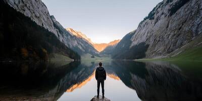 Man Standing Lake Mountain Reflection Sunrise Scenery photo