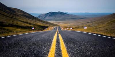 an empty road with yellow lines in the distance photo
