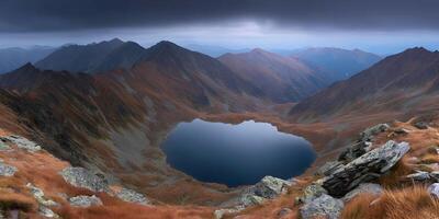 a lake surrounded by mountains and grass photo