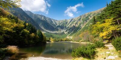 Autumnal Mountain Lake Landscape with Colorful Trees and Rocky Peaks photo