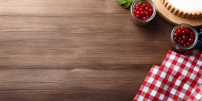 Wooden Table Top with Tart Berries and Red Gingham Napkin photo