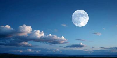Full Moon Night Sky Landscape with Clouds and Distant Mountains photo