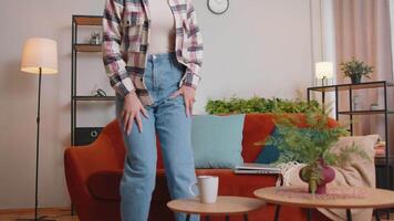 Caucasian young woman sitting on sofa opening laptop pc starting work at home office. Female girl freelancer working online, remote distance job. Cheerful lady elearning, browsing internet on computer video