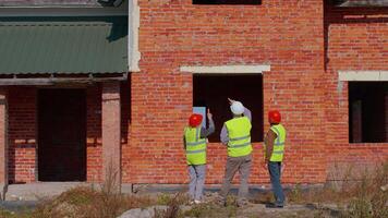 Architect inspector with senior civil engineers discussing project work of building house. Construction contractor working on construction site of apartment. Discussing planning, development, teamwork video