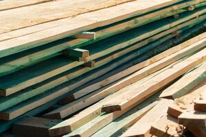 Wood timber in the sawmill. Piles of wooden boards in the sawmill. Wood, timber, wood blanks, construction material. photo