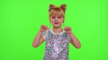 Young Blogger Concept. Cheerful teen school girl kid dancing at camera filming using phone at home on chroma key background, creating her trendy content on a mobile app to share on social media video