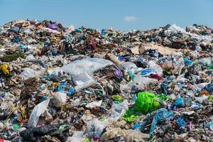 A lot of household waste in the landfill. The problem with waste processing. The topic of waste processing and pollution of the planet photo