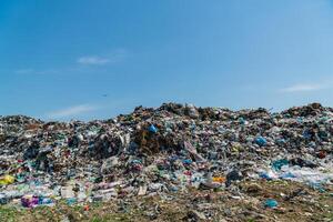 A large pile of garbage is in a landfill. Household waste garbage. Problems with waste processing photo
