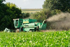 Combine tractor for field work. The combine tractor works in the field. Field work on a combine harvester photo