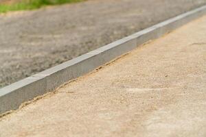 Construction of a pedestrian path. Laying the path with paving bricks. Construction works photo