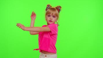 Happy funky young female blogger child kid girl, recording funny dancing on smartphone for social network or personal channel, having fun entertaining on weekend at home on chroma key background video