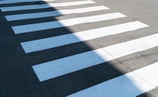 A crosswalk for pedestrians crossing the street. The crosswalk - zebra crossing photo