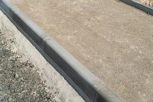 Construction of a pedestrian path. Paving of pedestrian paths on city streets. Road curbs and sidewalks photo