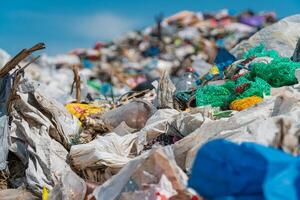 Pile of domestic garbage in landfill. Plastic scrap in landfill. Plastic and polyethylene waste photo