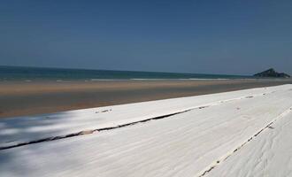 Empty white wooden table at ocean beach background video