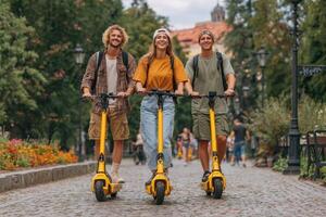 Three people riding on electric scooters photo