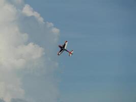 Aerobatic maneuvers by a stunt plane sky above aerial photography cloudy environment elevated viewpoint aviation concept for enthusiasts photo