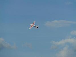 Aerial maneuver of a stunt plane open sky photography daytime high angle aviation excitement photo