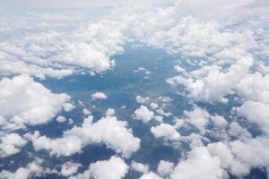 Aerial view of lush green landscapes and fluffy clouds above the earth nature photography serene atmosphere drone perspective nature's beauty photo