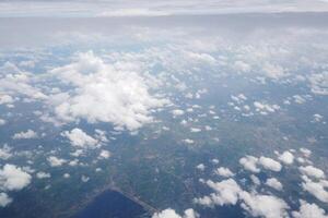Aerial view of clouds over green landscapes scenic flight nature photography open sky breathtaking perspective photo