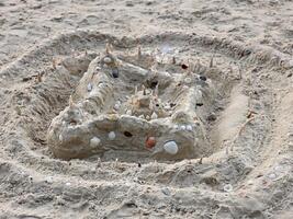 Creative sandcastle building beach artistic creation sandy environment close-up view imagination at play photo