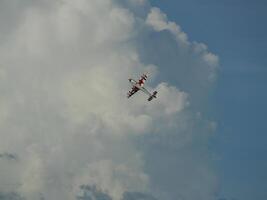 Aerobatic maneuvers showcase open sky aerial photography cloudy environment high angle aviation excitement photo