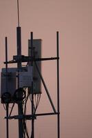 Telecommunication tower installation urban setting photography dusk light elevated view connectivity infrastructure photo