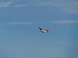 Aerial maneuvering airplane clear sky aviation photography outdoor high angle flight dynamics photo