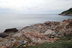 Coastal erosion action rocky shoreline seaside landscape calm waters natural setting environmental impact photo