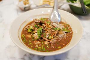 Delicious beef noodle soup street market food photography urban environment close-up view culinary delight photo