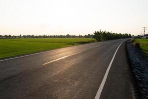 Serene rural road green fields landscape photography tranquil environment wide angle nature's beauty photo