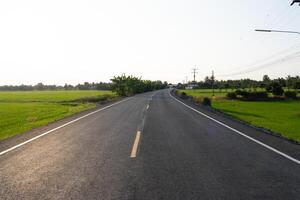 Winding road journey rural landscape photograph open fields eye-level view tranquility and adventure photo