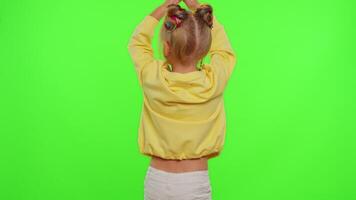 Happy funky young female blogger child kid girl, recording funny dancing on smartphone for social network or personal channel, having fun entertaining on weekend at home on chroma key background video