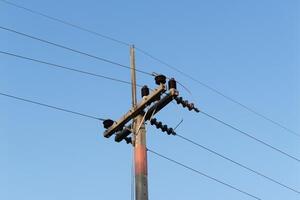 Power line infrastructure urban area electrical equipment clear sky ground view utility maintenance photo