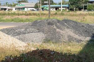 Construction activity roadside gravel pile urban setting ground level infrastructure development photo