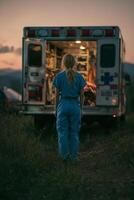 Medical Professional Stands Near Ambulance at Dusk in a Rural Area Preparing for Emergency Response. photo
