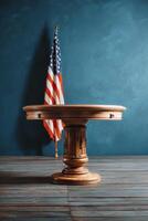 Wooden Table in Front of an American Flag Against a Blue Wall Backdrop photo