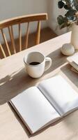 Cozy Workspace With Coffee and Open Notebook on a Wooden Table in Natural Light photo