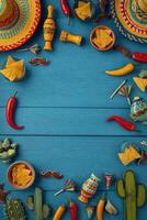 Colorful Fiesta Celebration Layout Featuring Hats, Snacks, and Drinks on Blue Wooden Table. photo
