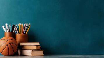 Basketball and Study Materials on a Teal Desk in a Creative Workspace. photo