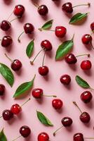 Fresh Cherries With Green Leaves Arranged on a Pink Background During Summer Season photo