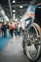 Wheelchair Positioned in Busy Convention Hall During Event With Many Attendees Present. photo