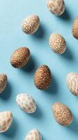 Easter Eggs With Intricate Designs Arranged on a Light Blue Background for Festive Celebrations. photo
