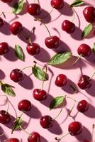 Bright Red Cherries Scattered on Pink Background for a Fresh Summer Feel. photo